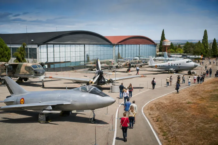 Avions historiques exposés en plein air près d’un hangar de musée aéronautique
